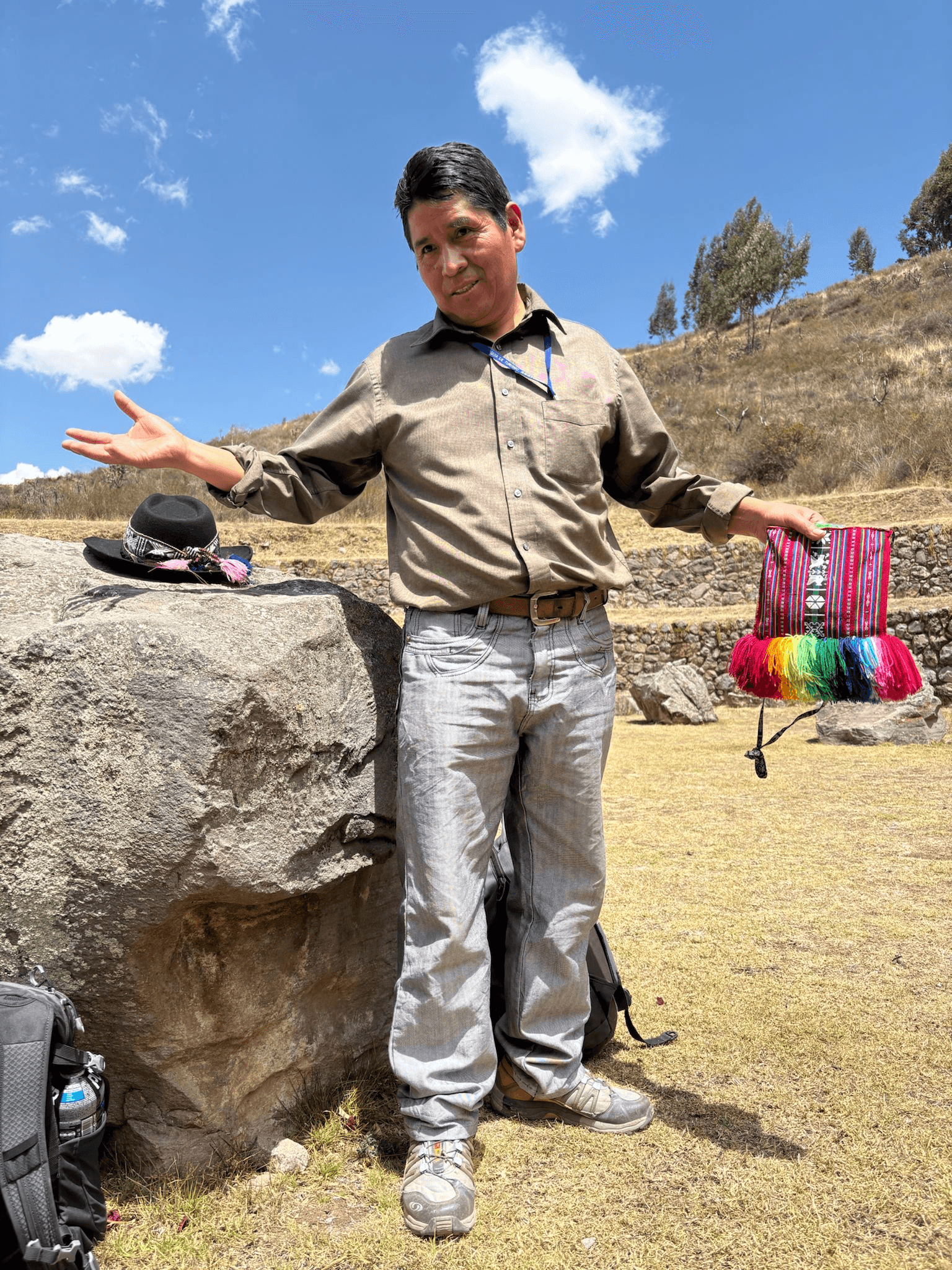 Wilbert Yucra Choqqucunsa in the Sacred Valley holding a handwoven textile.