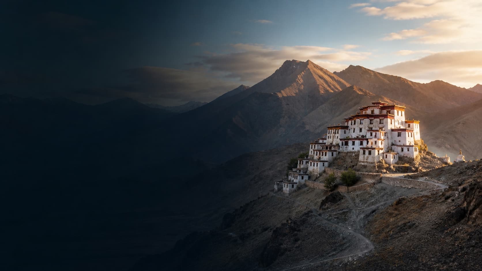 A whitewashed monastery in the high mountains of Ladakh at dawn.