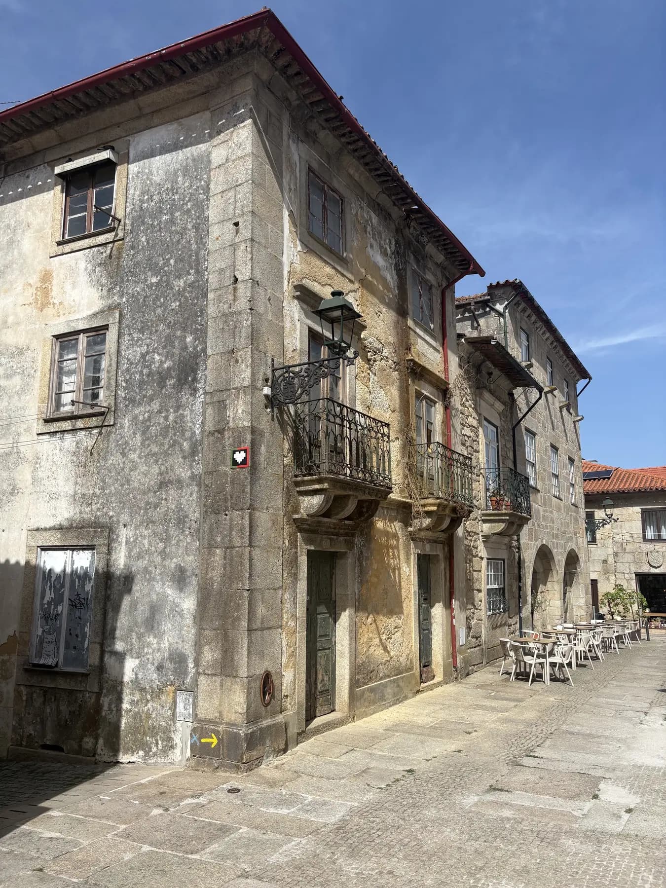 A yellow Camino arrow marking the route through Barcelos, Portugal.