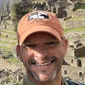 Jason Bedford smiling at Machu Picchu in Peru.